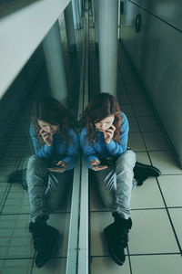 High angle view of woman sitting on staircase