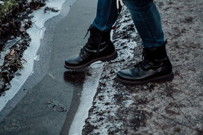 Low section of woman standing on street