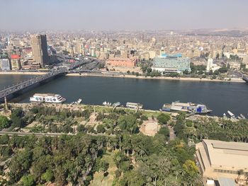 High angle view of river and cityscape against sky