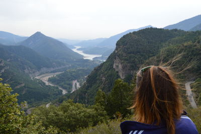 Rear view of woman against mountains