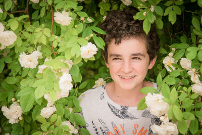 Smiling boy amidst flowering plants