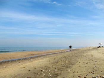 People on beach against sky