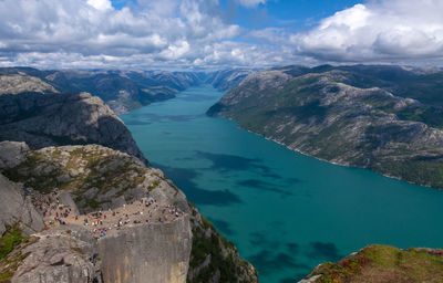 High angle view of sea and mountains against sky