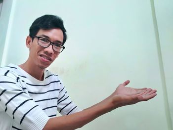 Portrait of young man against wall