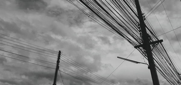 Low angle view of electricity pylon against sky