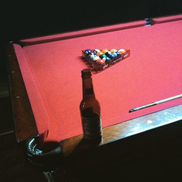 indoors, table, high angle view, toy, night, childhood, still life, selective focus, home interior, illuminated, wood - material, close-up, no people, multi colored, red, wall - building feature, shadow, flooring, full length, reflection