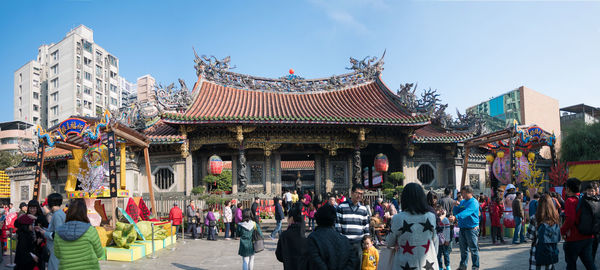 People at temple against clear sky