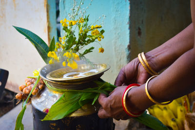 Midsection of woman holding flower bouquet