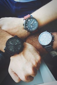 High angle view of hand holding clock