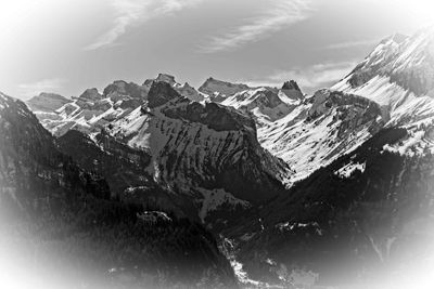 Aerial view of snowcapped mountains against sky