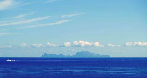 Scenic view of sea against blue sky