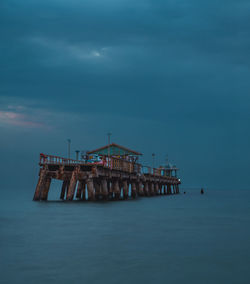 Pier over sea against sky