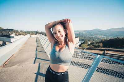 Side view of woman standing against sky