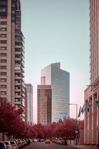 City buildings against clear sky during sunset