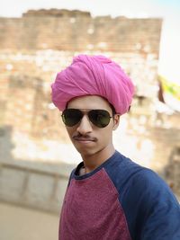 Portrait of man wearing pink turban while standing outdoors