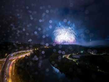 Firework display in city at night