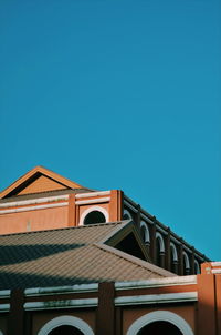 Low angle view of building against clear blue sky