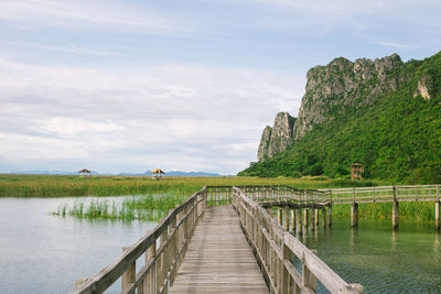 Pier over lake against sky