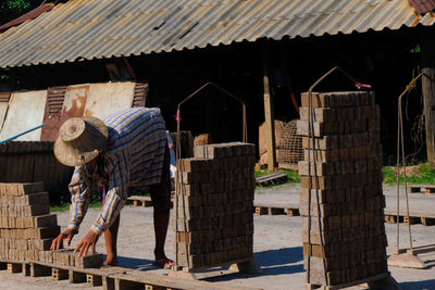 Man stacking bricks at construction site