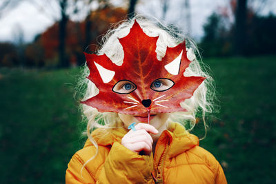 Portrait of woman holding red umbrella