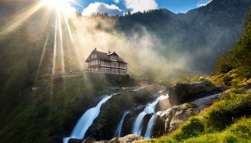 Scenic view of waterfall against sky