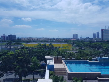 View of swimming pool against buildings in city