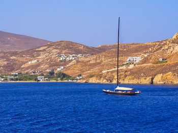 Boats in sea against clear sky