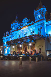 Illuminated building against sky at night