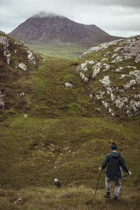 Women walk wild mountains in scottish highlands