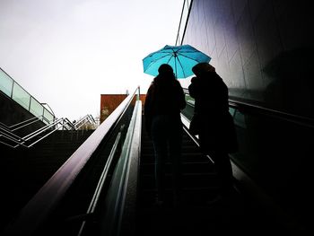 Low angle view of silhouette people on steps