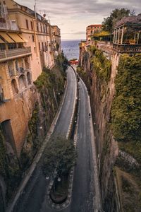 Road by city against sky