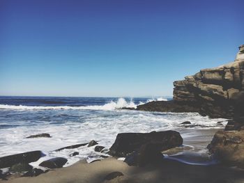 Scenic view of sea against clear blue sky