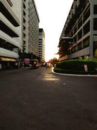 Road amidst buildings against sky in city