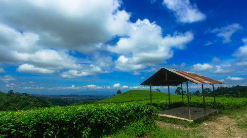 Built structure on countryside landscape against cloudy sky