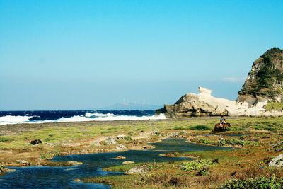 Scenic view of sea against clear blue sky