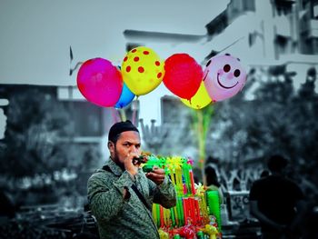 Smiling boy holding balloons