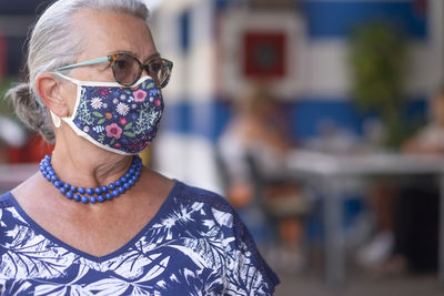 Close-up of smiling woman looking way outdoors