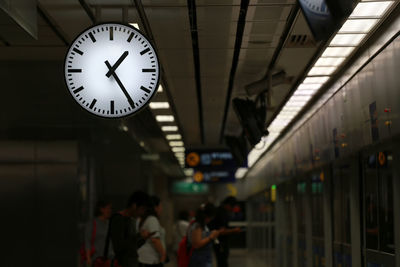 People waiting at railroad station platform