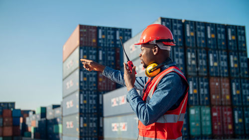 Side view of man standing in factory