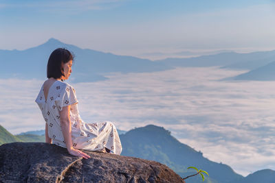 Woman looking at cloudscape during sunset