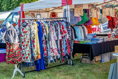 Multi colored flags hanging in rack for sale at market stall