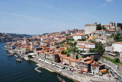 High angle view of river amidst buildings in town against sky