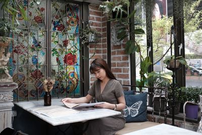 Young woman sitting on table