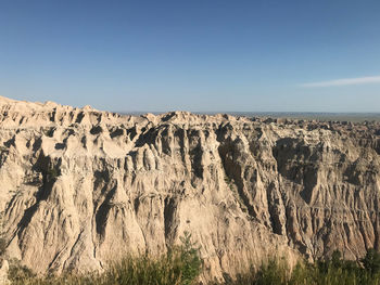 Panoramic view of rocky mountains against clear sky