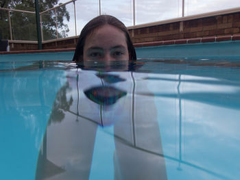 Portrait of girl swimming in pool