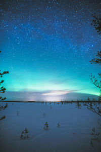 Scenic view of sea against star field at night