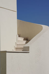 Low angle view of staircase against blue sky