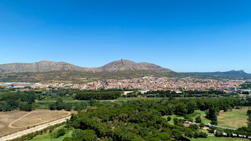 Scenic view of townscape against clear blue sky