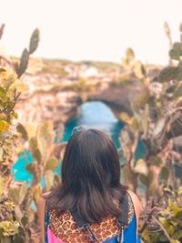 Rear view of woman looking away in broken beach