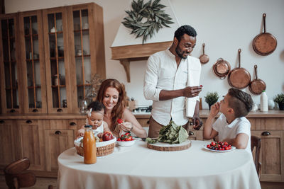 Group of people sitting on table at home